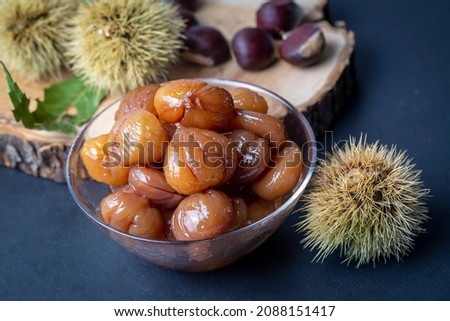 Chestnut dessert and chestnuts on a plate. Traditional delicious Turkish dessert; chestnut candies (Kestane Sekeri) Royalty-Free Stock Photo #2088151417