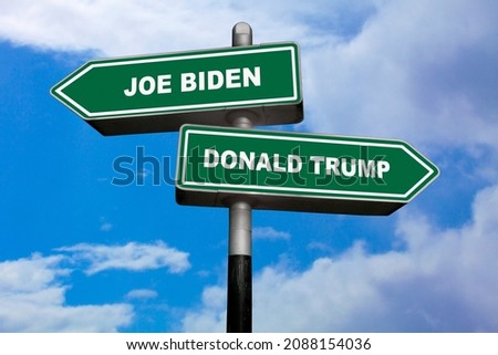 Two direction signs, one pointing left (Joe Biden), and the other one, pointing right (Donald Trump). Royalty-Free Stock Photo #2088154036