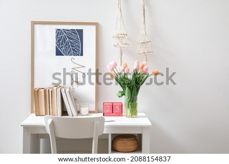 Bouquet of beautiful tulip flowers in interior of modern workplace