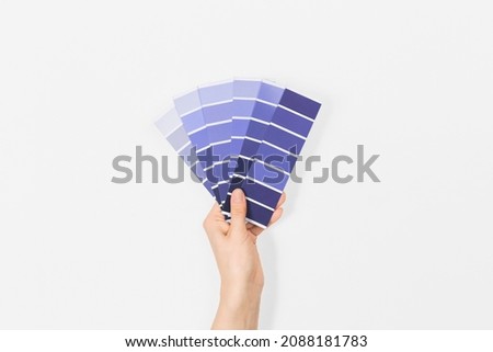 Color swatches with color of the year 2022 in the hand - Very Peri. Color trend palette. Top view, flat lay.  Royalty-Free Stock Photo #2088181783