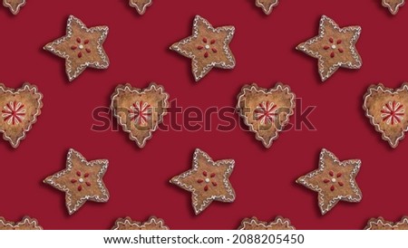 Pattern of stars and hearts ginger cookies on red background for Christmas season