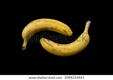 Two falling bananas on a black background. Background for t-shirt, print, cover.