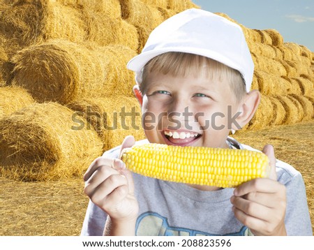 boy eating a hot summer corn