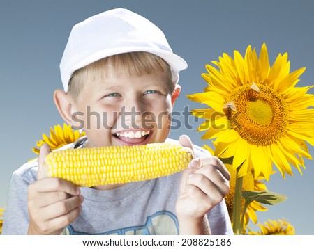 boy eating a hot summer corn