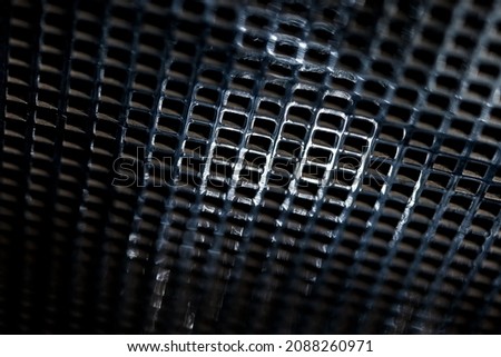 Perspective view on chrome metal grill with selective focus. Small depth of field.