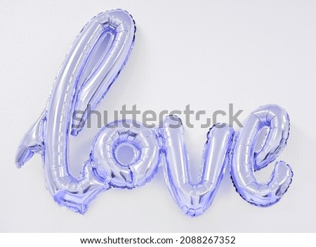 inflatable word love in Very Peri color of the year 2022. trendy balloon for holiday celebration.