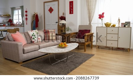 interior of a cozy bright home interior with chinese lunar new year decorations in living room and kitchen. chinese text translation: spring and congratulations everyone Royalty-Free Stock Photo #2088267739