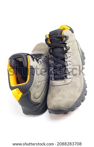 Gray hiking boots with ginger inserts on a white background.