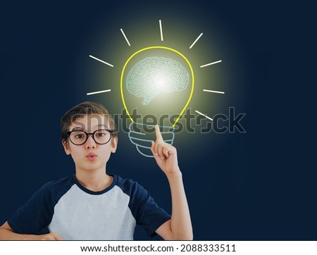 An intelligence happy looking boy in eyes glasses  pop up an idea with light bulb and the brain inside, got a new ideas concept.