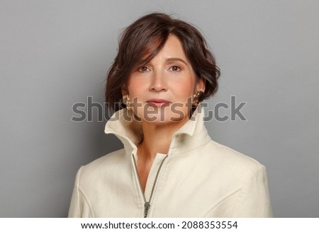 Mature and gorgeous woman portrait. Headshot of a beautiful and respectable 50-60 years woman. Royalty-Free Stock Photo #2088353554
