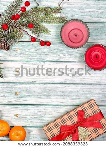 Christmas festive background of pine branches, ornaments and gifts with tangerines on vintage boards. The concept of a holiday card.