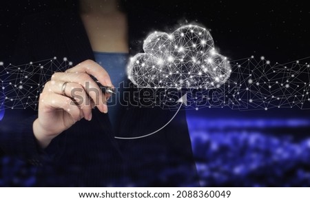 Download Data Storage Business Technology Network Concept. Hand holding digital graphic pen and drawing digital hologram cloud, download, data sign on city dark blurred background