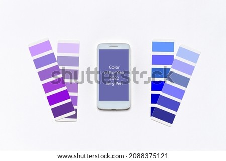 Color of the year 2022 very peri. Violet and blue swatches, smartphone screen with very peri color background. Fashionable pantone color. Main color trend of 2022 year