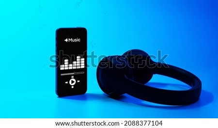 Music concept. Audio beats, sound headphones, music application on mobile smartphone screen. Record sound voice on blue gradient background. Recording studio or podcasting banner with copy space