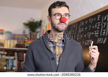 Humorous teacher wearing red clown nose 