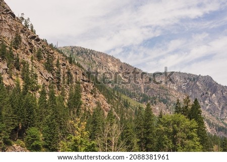 Pacific Northwest mountain pass with trees and clouds and blue sky summer vacation