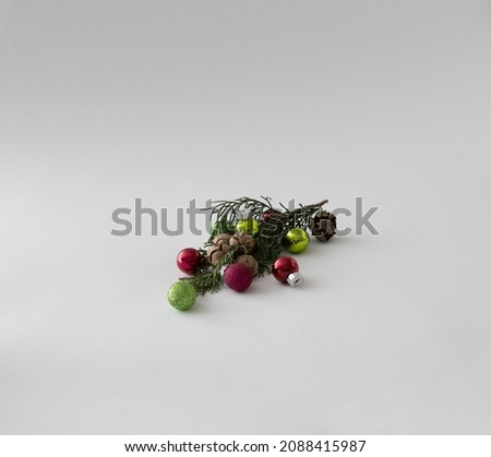 Christmas tree with red and green baubles on a white background. Minimal idea. New Year's cincept.