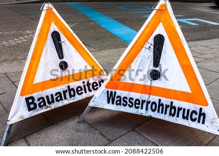 men at work warning sign in germany - translation: under construction - burst pipe