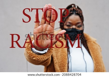 Stop racism. African american woman, wear black face mask show stop hand sign. 