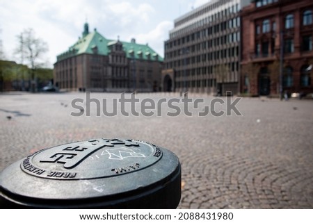 Closeup of the key of Bremen as a symbol for free market rights and the historic town hall (unesco world cultural heritage) in the background