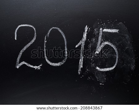 Year number 2015 written with the white chalk on the blackboard