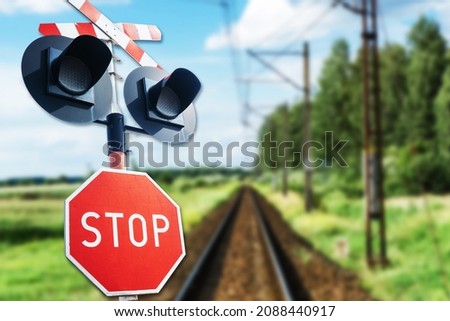 Stop sign background. Long railway landscape. Road sign suggesting caution. Watch out for a train. Rail crossing danger background. Royalty-Free Stock Photo #2088440917
