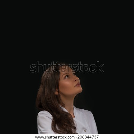 Thinking medical doctor woman looking up contemplative and thoughtful. Lots of copy space
