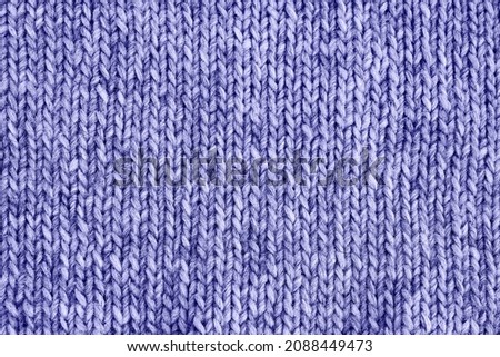 Lilac very peri knitted texture. Handmade Knitwear. Color of the year 2022 very peri toned. Abstract background, copy space. Royalty-Free Stock Photo #2088449473