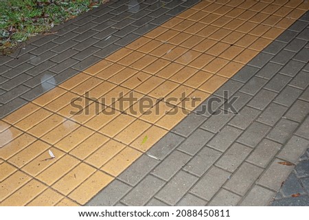 Walking on the pavement with yellow striped lines road