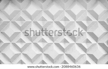 Background texture of square 3d white tiles on facade. Street stone cement wall with geometric rhombus pattern, concrete light gray polygons. Building cladding, architectural masonry