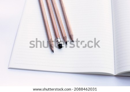 Pencils on notebooks or paper on white background