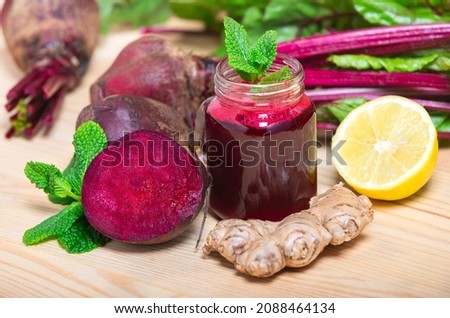 Red Beetroot, ginger and lemon smoothie on wooden Background. homemade detox drinks