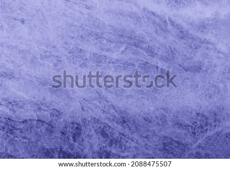 Granite texture background of natural stone toned in trendy Very Peri color of the Year 2022 pantone. marble texture used for indoor and outdoor home decoration