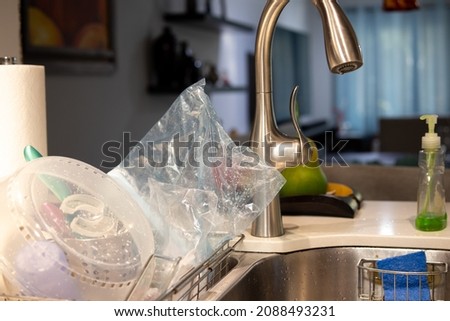 re-sealable bag washed and cleaned, drying on the sink for reuse  Royalty-Free Stock Photo #2088493231