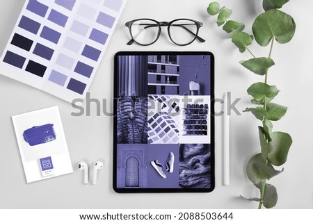 Workplace with Tablet, coffee and New 2022 trending PANTONE 17-3938 Very Peri color