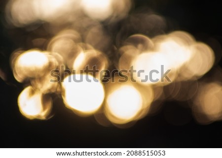 lights blurred by bokeh. Background rough and abstract. 