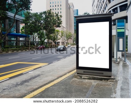 Vertical blank billboard ad mock up at a bus stop in the Central Business District of Singapore. Royalty-Free Stock Photo #2088526282