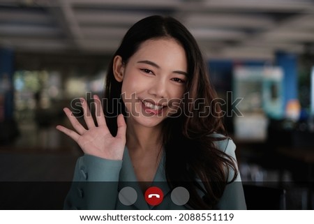 Happy Business Woman having video call with her team by application on laptop.