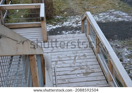 platform of a lookout tower made of oak logs and planks with barrier-free access for seniors and the immobile. wheelchair ramp. metal railings of stainless steel polished tube