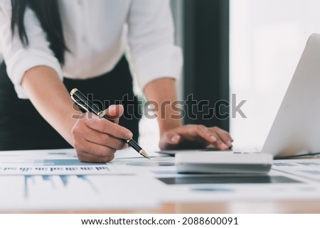 Financial inspector calculating a numbers in office room.