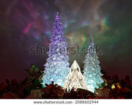 Illuminated Christmas Trees isolated on colorful blurred background.