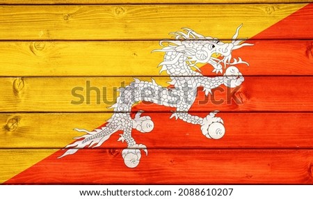 Flag of Bhutan on wooden surface 