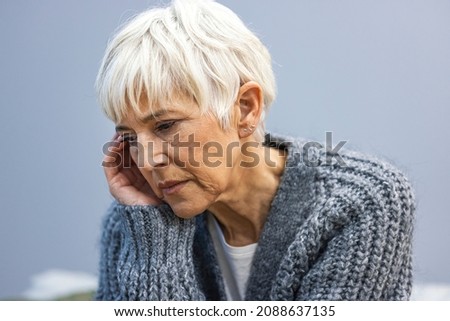 Head shot close up portrait thoughtful middle aged retired woman worrying about personal health problems. Upset older female retiree thinking of family troubles, feeling lonely, sitting at home. Royalty-Free Stock Photo #2088637135