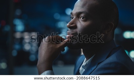 Portrait of a Financial Project Manager Working on Computer in an Office Late in the Evening. African American Businessman at Work in Investment Broker Agency. Royalty-Free Stock Photo #2088647515