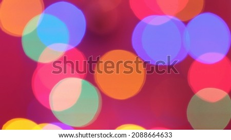 Christmas mood, round defocused lights. Beautiful festive screensaver. Merry christmas congratulation. Abstract background of glowing garlands at night in the dark.