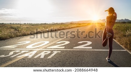 New year 2022 or straight forward concept.Word 2022 written on the road in the middle of asphalt road at sunset.Concept of planning and challenge,hope,new life change,business strategy,opportunity  Royalty-Free Stock Photo #2088664948