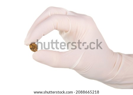 Cholelithiasis (gallbladder stone) after successful operation in the hands of a surgeon isolated on white background Royalty-Free Stock Photo #2088665218