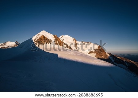 View of Gemini or Zwillinge, famous 4000 meter peaks in Monte Rosa Masiff, Switzerland and Italy. High alpine moutain landscape of Wallis alps. Summit of Castor and Pollux, glacier, snow.