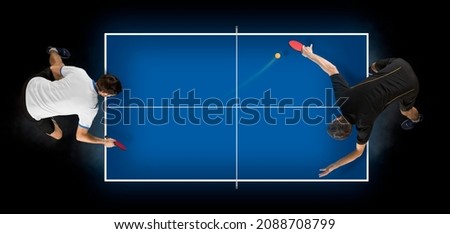 Two men playing ping pong. Top view. Copy space background. Two image of the same model Royalty-Free Stock Photo #2088708799