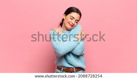 young pretty woman feeling in love, smiling, cuddling and hugging self, staying single, being selfish and egocentric Royalty-Free Stock Photo #2088728254